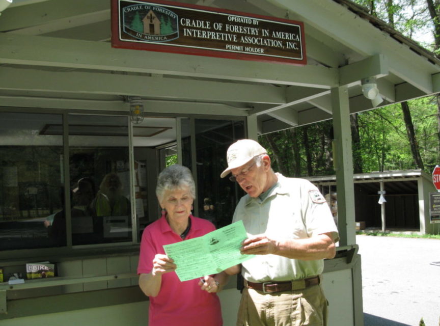 Hosts assist visitors with information.